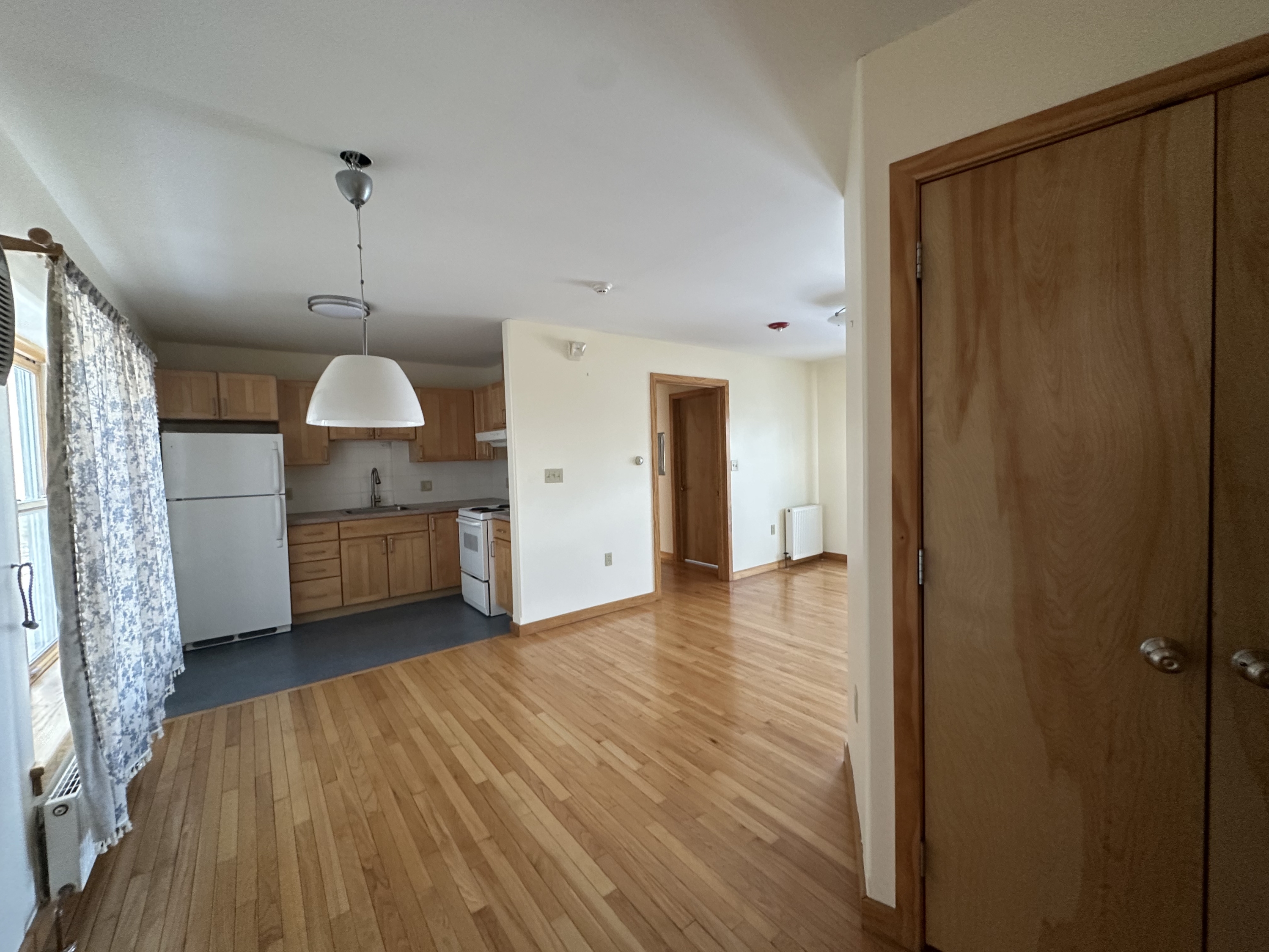 From the front door you can see the large coat closet on your left, kitchen, and eat in dining area